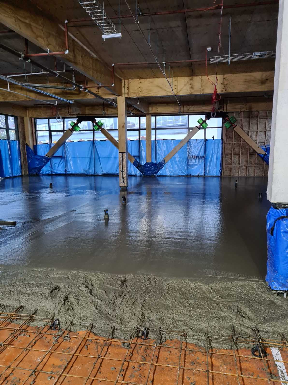 Concrete floor being poured during light commercial construction project in Wellington.