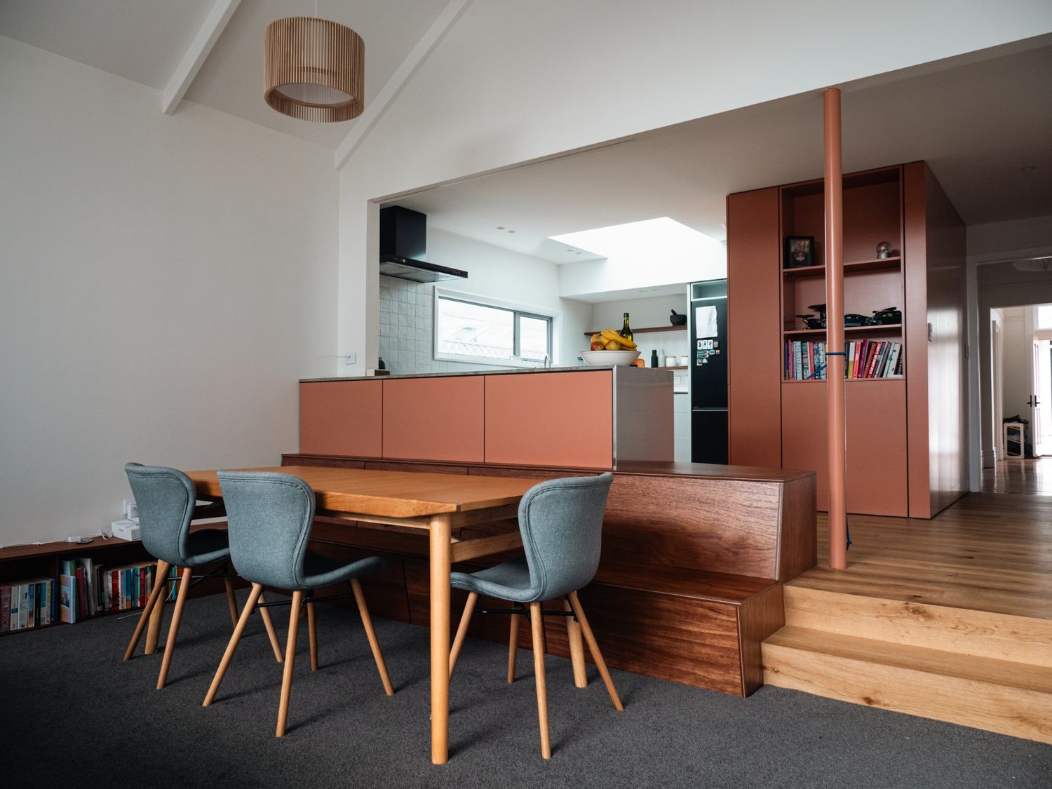 Renovated kitchen and dining area in a 1901 Thorndon villa by Clearcut Building Solutions, featuring warm timber finishes, modern cabinetry, and a split-level layout.