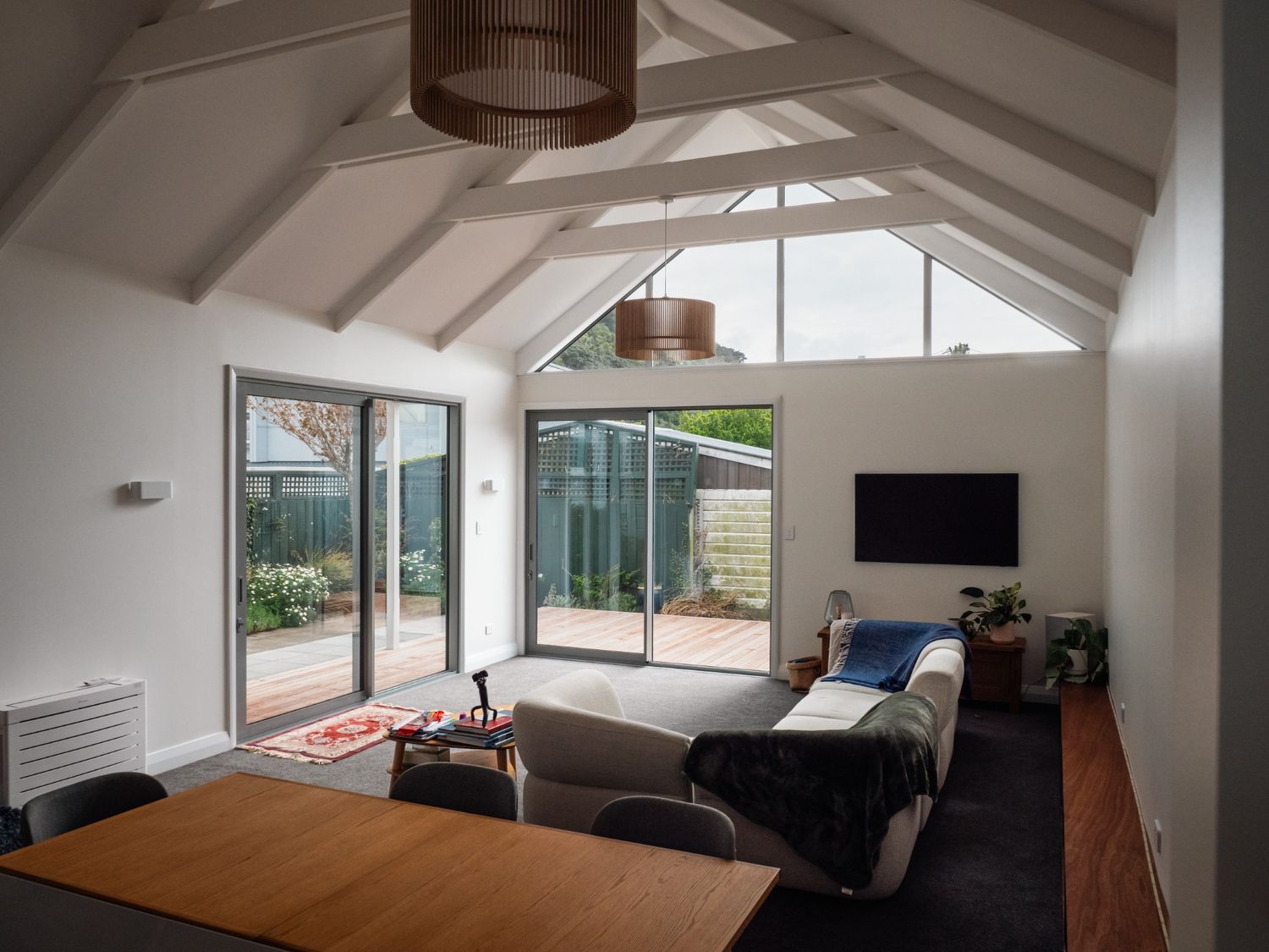 Open-plan living area of the renovated 1901 Thorndon villa by Clearcut Building Solutions, featuring vaulted ceilings, natural light, and seamless indoor-outdoor flow.