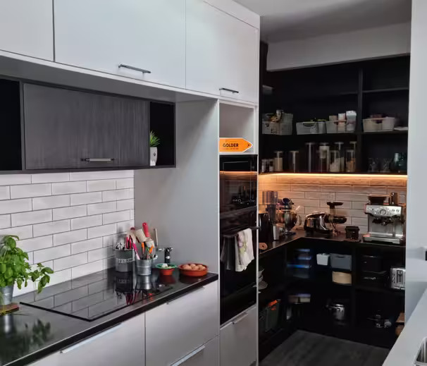 Small modern kitchen with built-in storage and a tidy scullery in a Lower Hutt renovation.