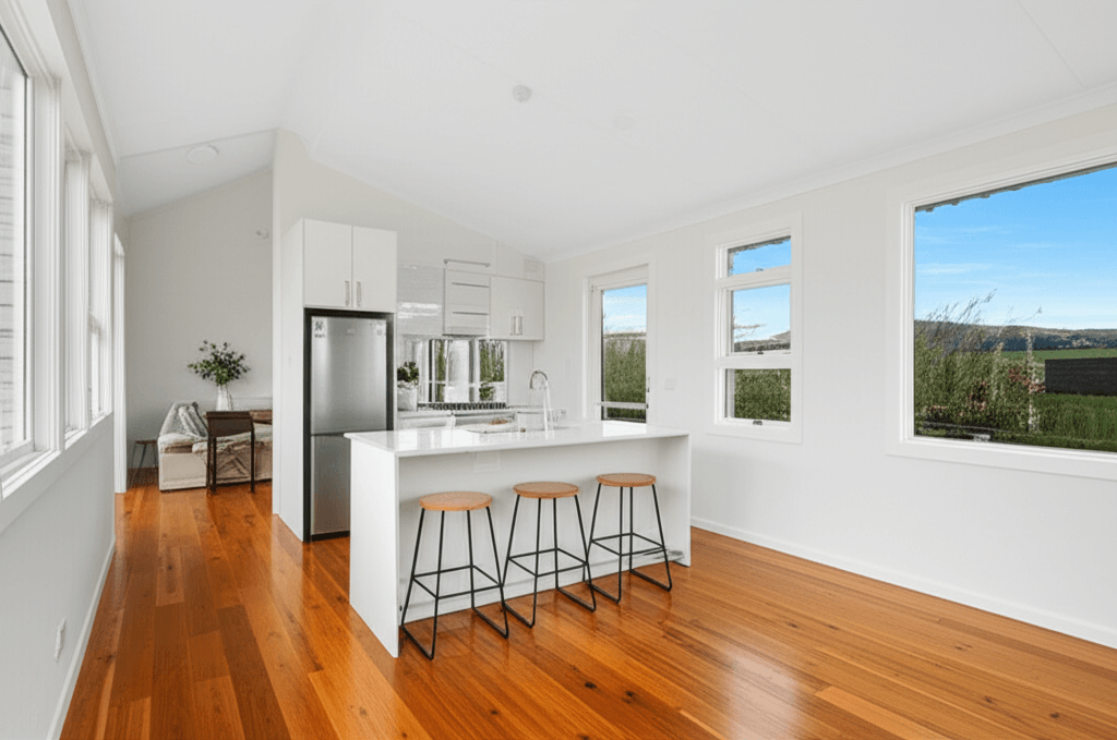 Bright open-plan interior of a modern granny flat with kitchen and living area