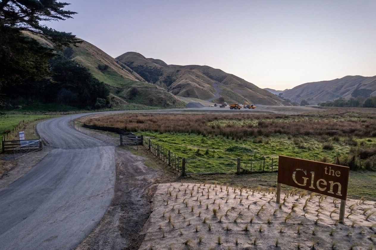 The Glen entrance sign at Grays Road Pauatahanui with hills and earthworks in background