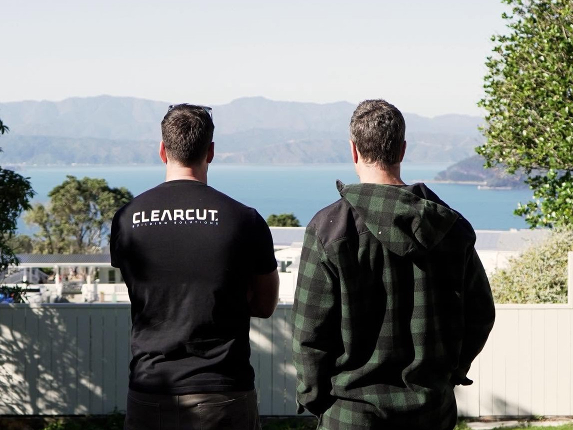 Clearcut Building Solutions team overlooking Wellington harbour from a project site